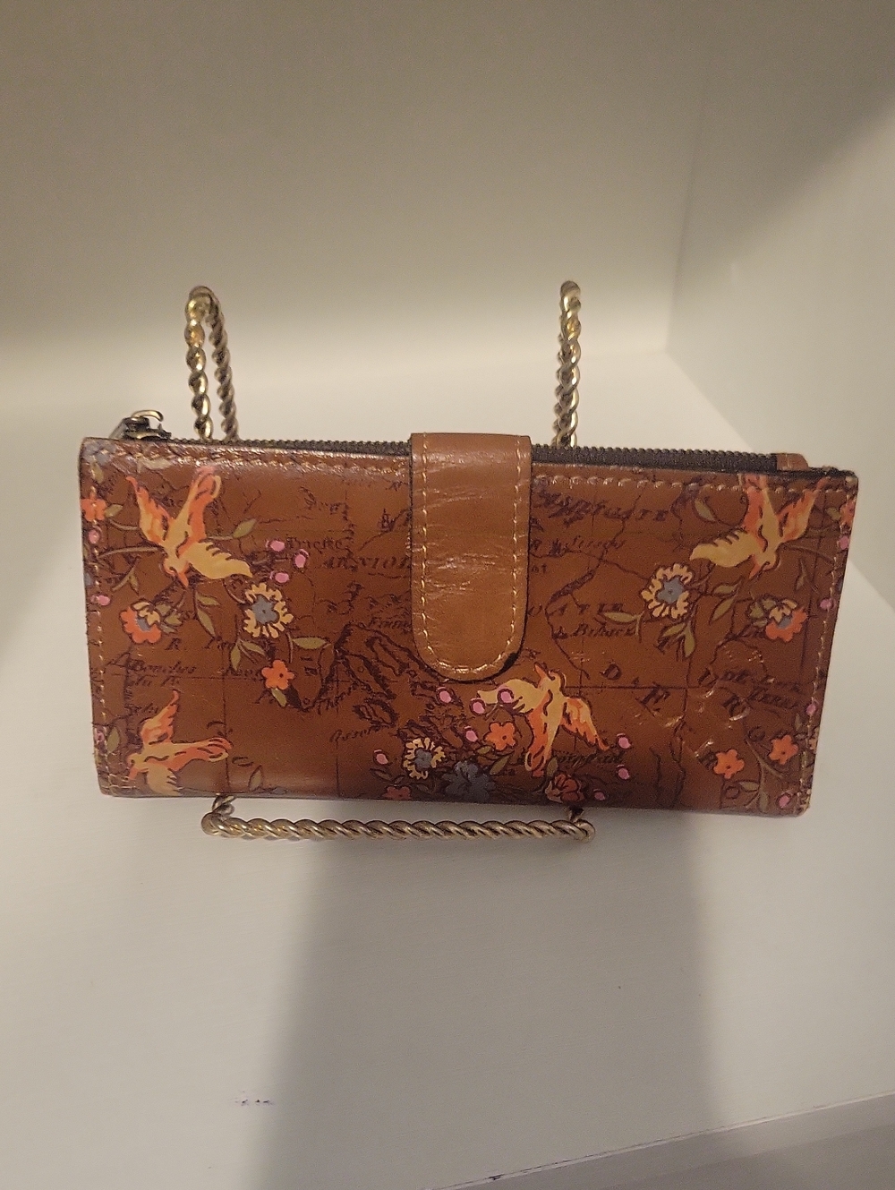 Brown leather Patricia Nash bifold wallet featuring an artistic vintage map back